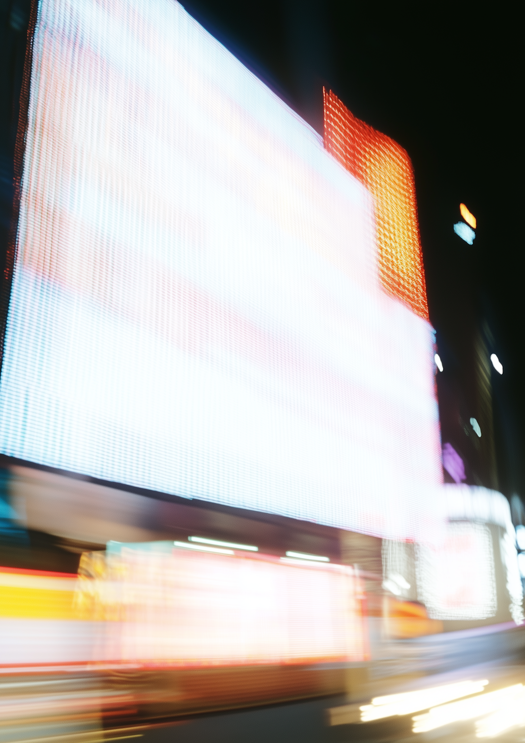 Blurred neon lights on a city street at night
